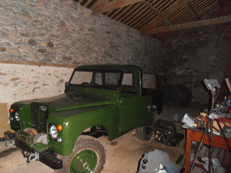 Front/side view of Green Land Rover Series 2a with roof fitted. Almost ready to drive out.